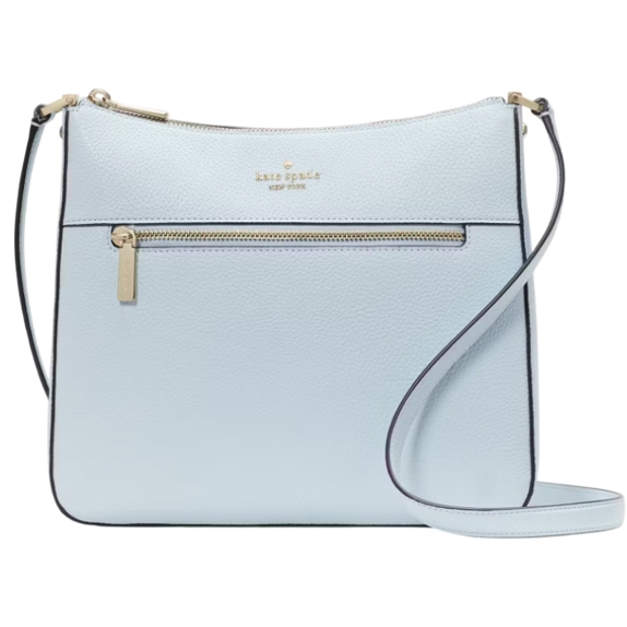 A pale blue Kate Spade large crossbody bag with a pebbled texture, featuring a front zipper pocket, gold-tone hardware, a slim adjustable strap, and the Kate Spade logo embossed at the top center.