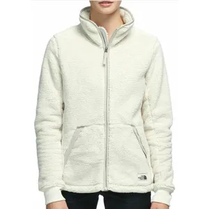 A cream-colored fleece jacket with a full front zipper and two pockets, featuring The North Face logo near the hem.
