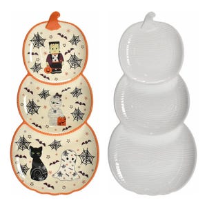 A set of four pumpkin-shaped platters stack to form a pumpkin silhouette, featuring Halloween-themed illustrations of a vampire, mummy, black cat, and spiderwebs. The reverse side is white with a ribbed texture.