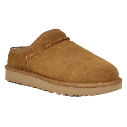 A tan suede slip-on shoe with a flat sole and a sheepskin lining, resembling a casual slipper style.