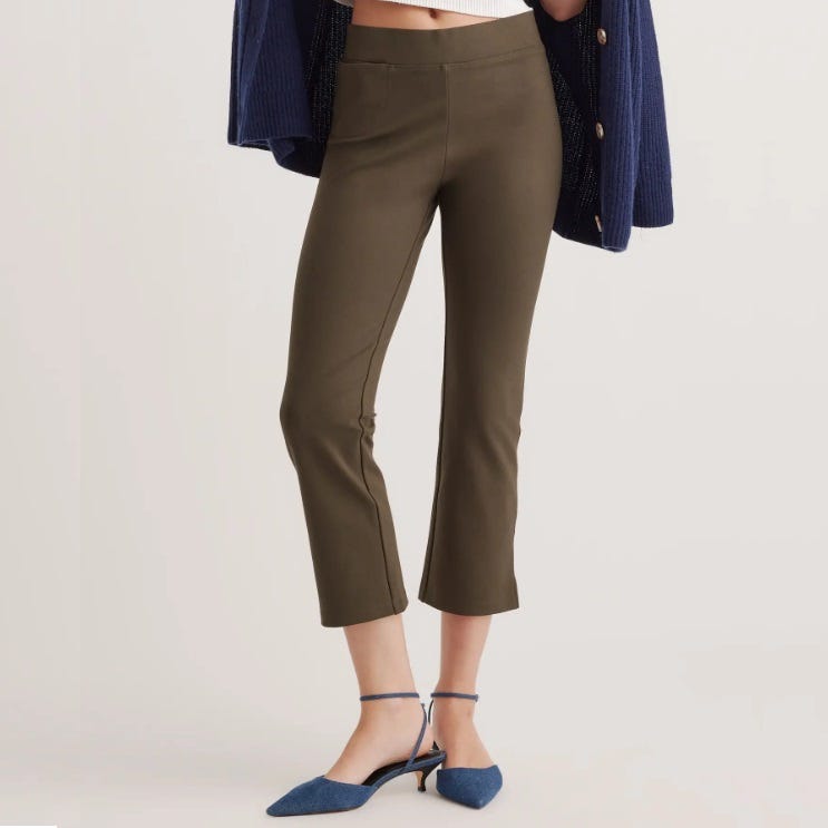 Olive green cropped pants paired with blue ankle-strap heels.