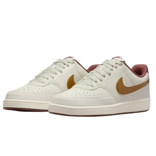 A pair of low-top white sneakers with a brown swoosh and maroon lining, featuring perforated toe caps and white laces.