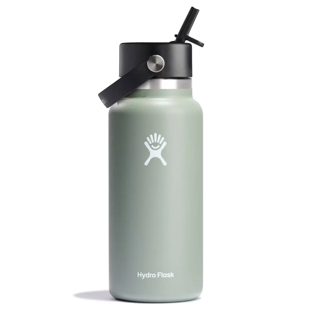 A light green Hydro Flask bottle featuring a black cap with a built-in straw and a carrying handle.