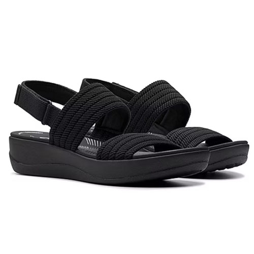 A pair of black sandals with a stretchy, woven upper and slingback design, featuring a cushioned wedge sole for comfort.