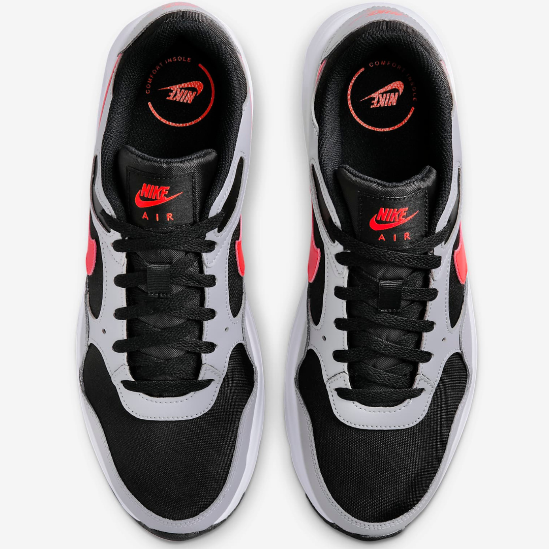A pair of Nike Air sneakers with a black and white color scheme and red accents.