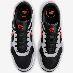 A pair of Nike Air sneakers with a black and white color scheme and red accents.