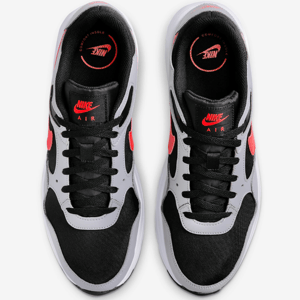 A pair of Nike Air sneakers with a black and white color scheme and red accents.