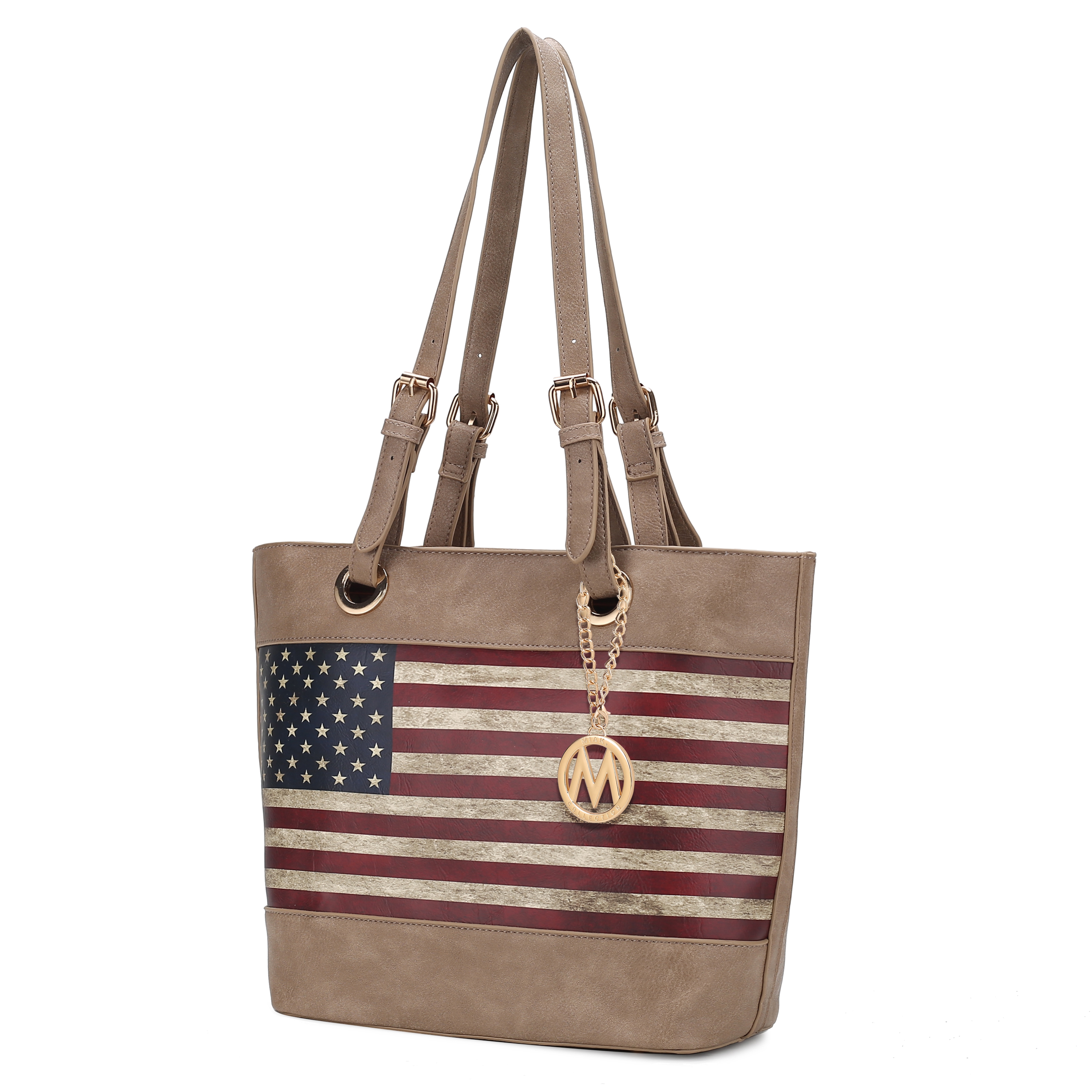 A tan handbag with dual straps features a vintage-style American flag print and a gold circular charm with a chain.