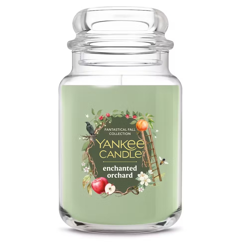 Yankee Candle from the Fantastical Fall Collection, scent \“Enchanted Orchard,\“ in a large glass jar with a green hue and botanical-themed label.
