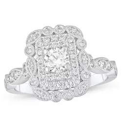 Ornate white gold ring with a central round diamond surrounded by a rectangular cluster of smaller diamonds and intricate milgrain detailing.