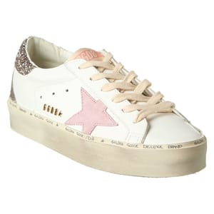 White sneaker with a pink star and glitter detail on the heel.