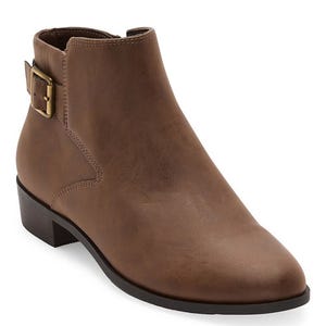 A brown ankle boot with a low stack heel features a side buckle detail and a zipper on the inner side for closure.