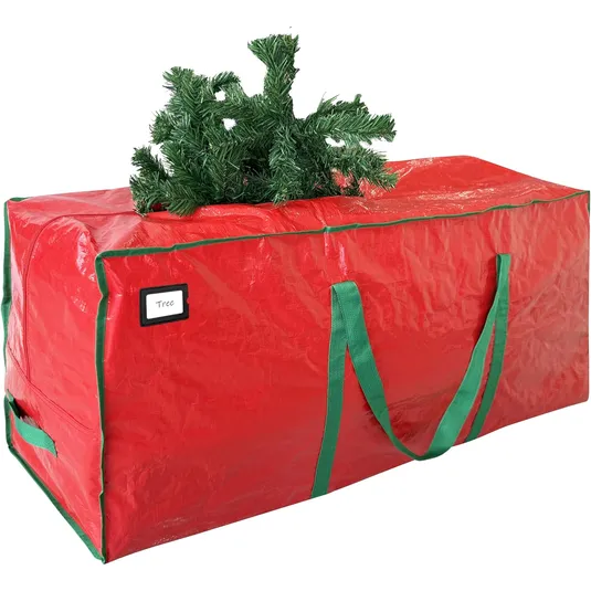 Red storage bag with green handles labeled \“Tree,\“ holding parts of an artificial Christmas tree.