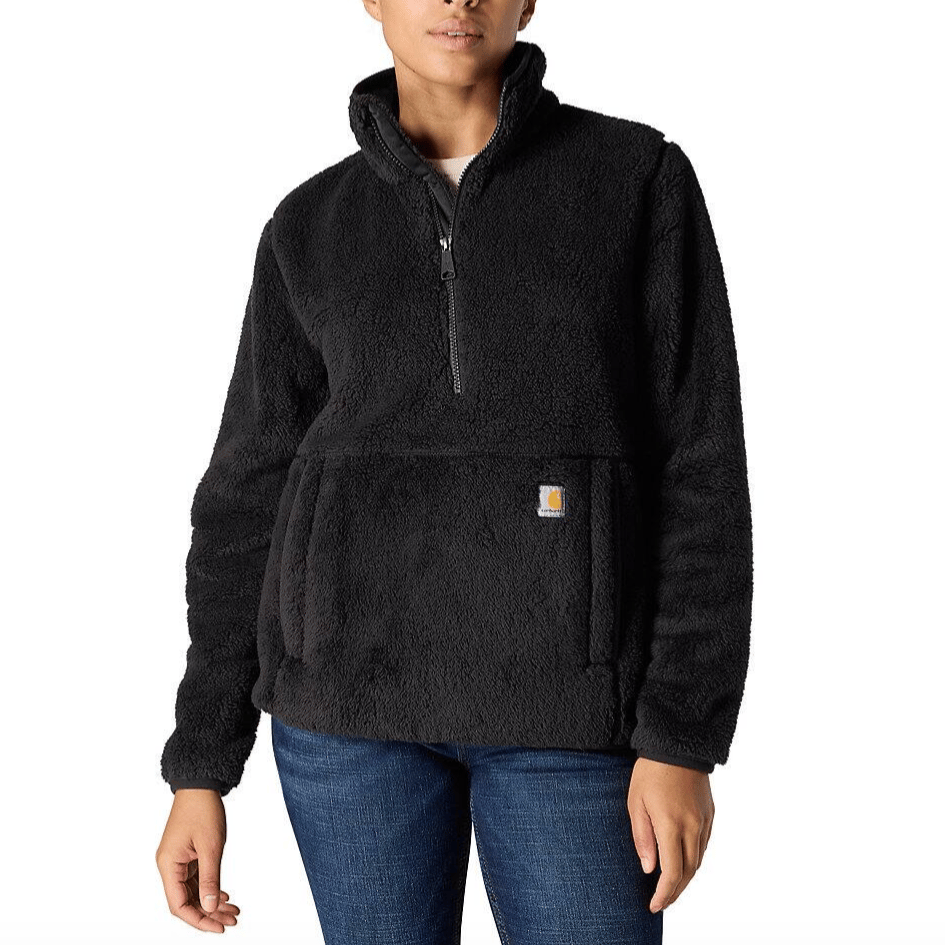 A person is wearing a black sherpa fleece pullover with a quarter-zip and front kangaroo pocket.