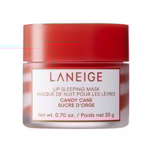 Laneige Candy Cane Lip Sleeping Mask is a red jar containing 20g (0.70 oz) of lip treatment designed to be worn overnight, featuring a candy cane flavor for hydration and repair.