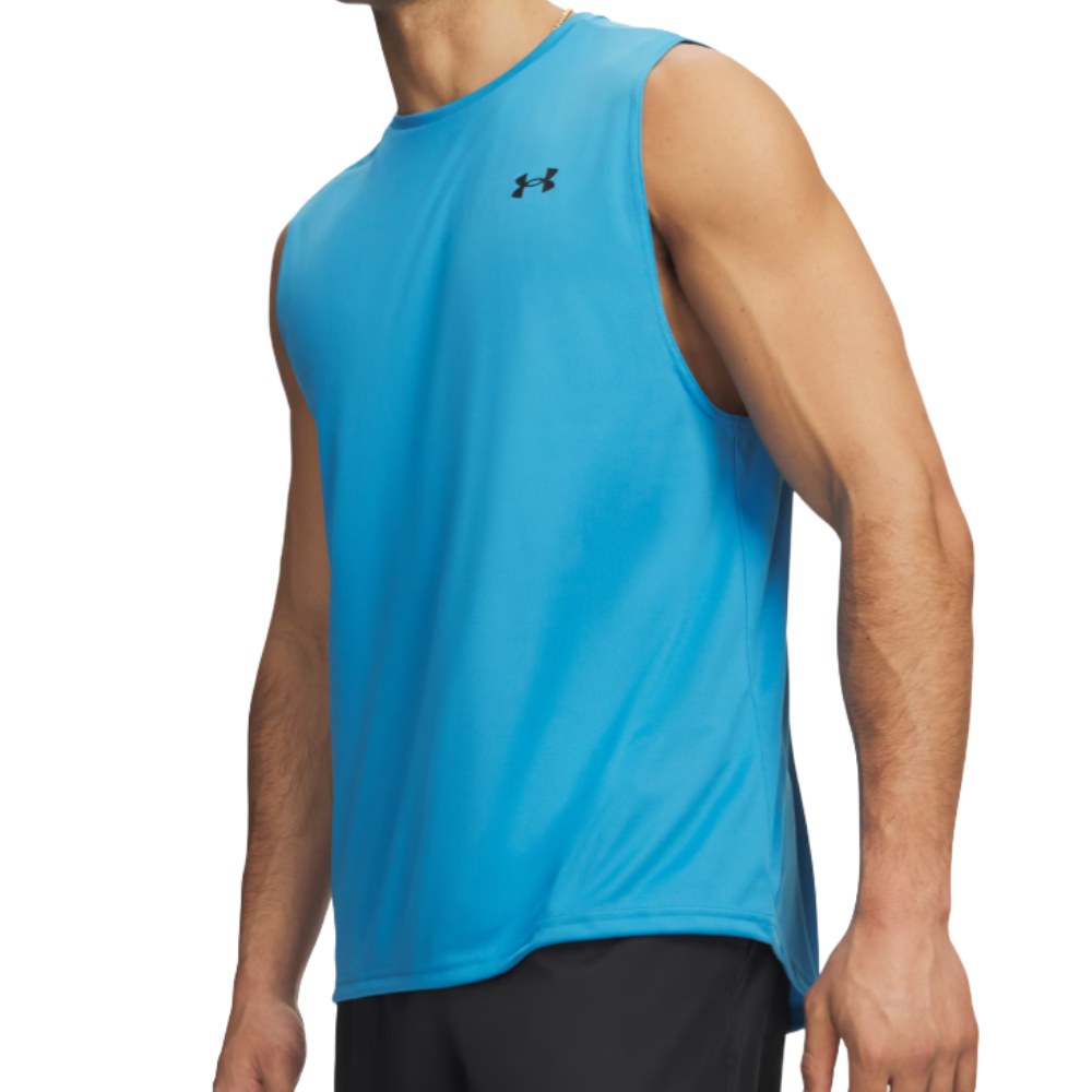 A person wearing a blue sleeveless athletic top with a small black logo on the chest, paired with black shorts.