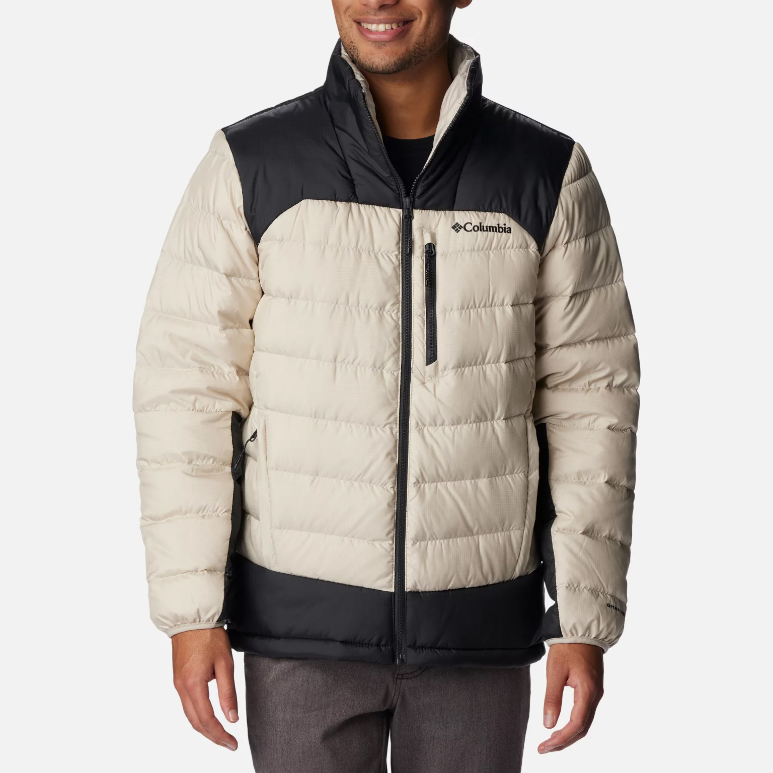A man wearing a two-toned Columbia branded puffy jacket with a zip front.