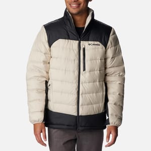 A man wearing a two-toned Columbia branded puffy jacket with a zip front.