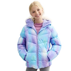 A colorful ZeroXposure winter jacket with a pastel tie-dye pattern, featuring a zip-up front, quilted design, and a plush purple sherpa-lined hood, worn over a pink top.