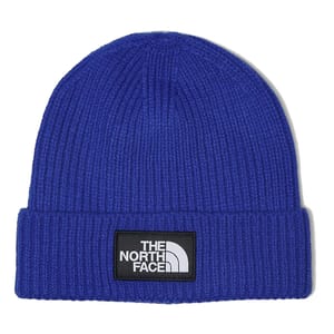 Blue ribbed knit beanie with a cuff, featuring a black patch with the white \“The North Face\“ logo on the front.