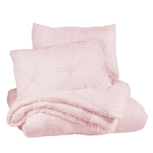 Light pink bedding set with tufted patterns, including a comforter and two pillow shams.