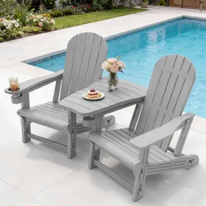 Two gray Adirondack chairs connected by a shared table with a vase of flowers and a plate of pancakes, positioned by a pool. One chair features a built-in cup holder with a glass of iced tea.