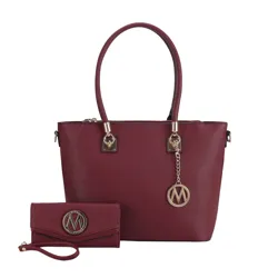 A burgundy handbag with gold hardware and a matching wristlet, both featuring a circular emblem with the letter \“M.\“