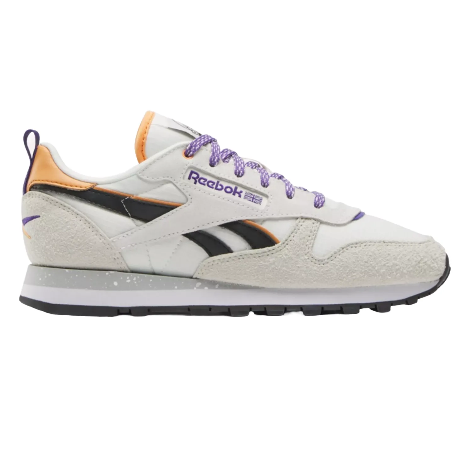 Reebok Classic Leather Shoes feature a white base with textured suede overlays, black and orange accents, purple laces, and branding. The shoe has a retro style with a speckled midsole and black outsole for grip and durability.