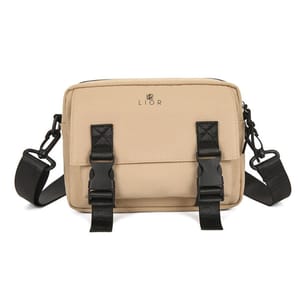 A beige crossbody bag with black adjustable straps and dual front buckle closures, featuring the brand name \“LIOR\“ on the front.