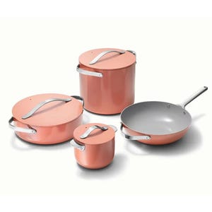 A set of four copper-colored cookware items with lids, including two pots, a pan, and a saucepan.