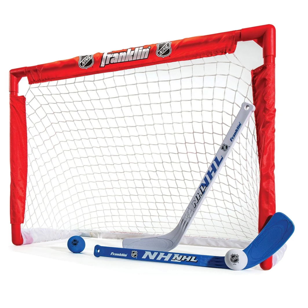 A red and white hockey net with two blue and gray hockey sticks and a soft blue ball, all featuring the NHL and Franklin logos.