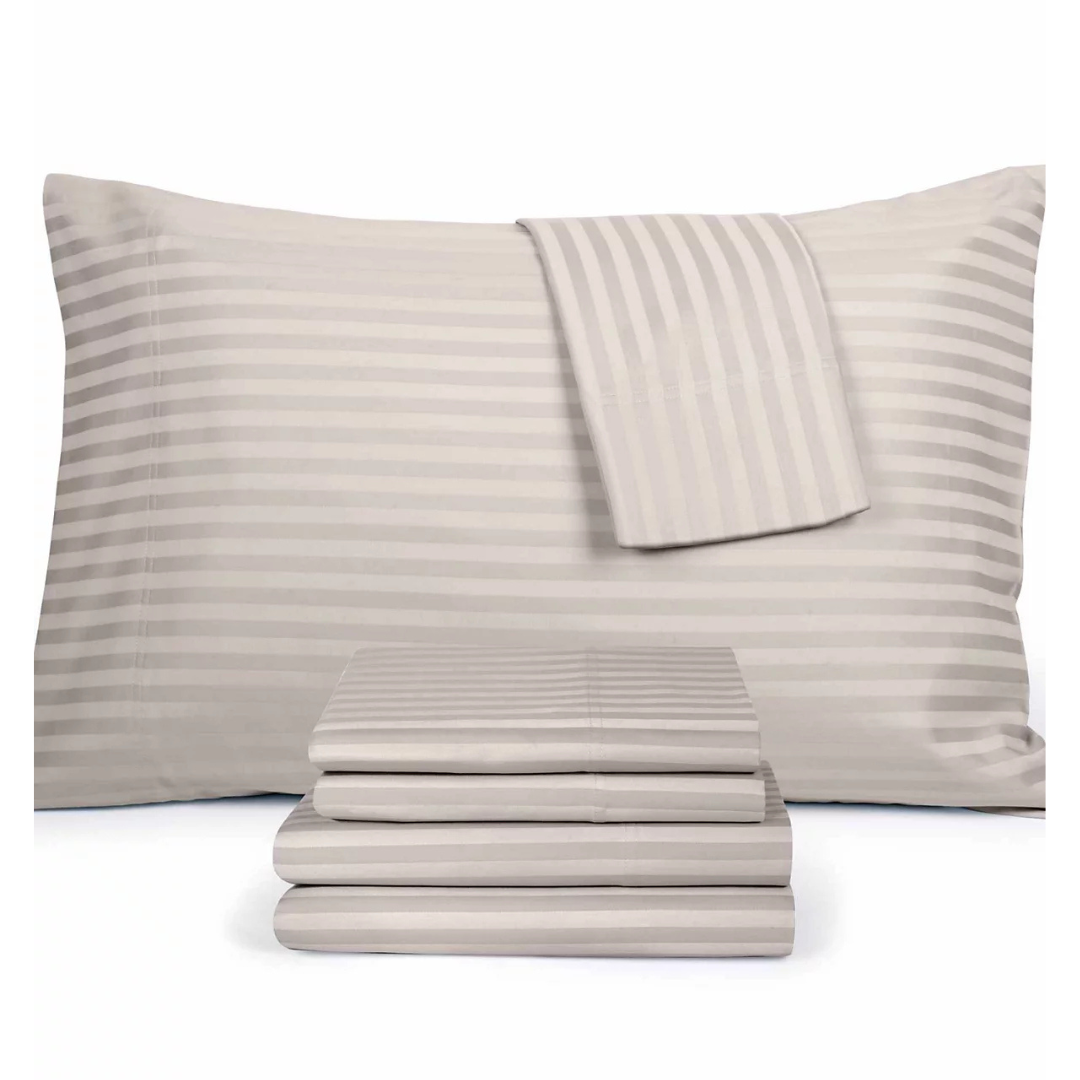 A set of striped bedsheets in a light, neutral color, including pillowcases and folded sheets.