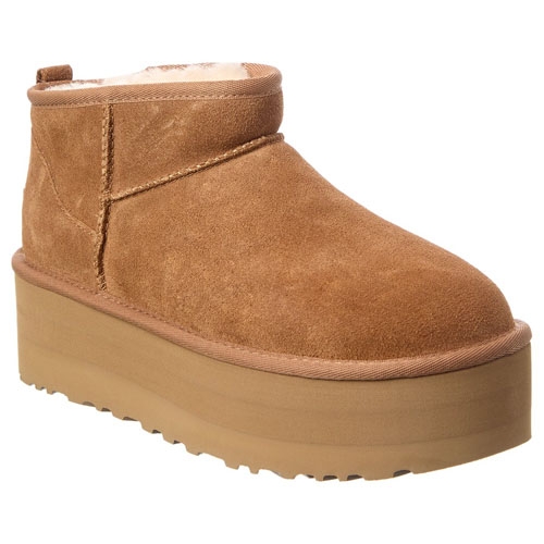 A tan suede platform boot with a thick sole and shearling lining.