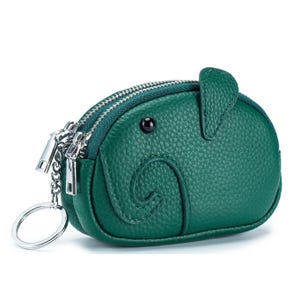 Green, elephant-shaped coin purse with black eye details, double zippers, and a keychain attachment.