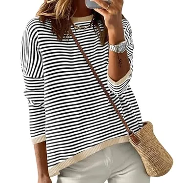 A person is wearing a striped black and white sweater with a light brown trim, paired with light pants and carrying a woven crossbody bag.
