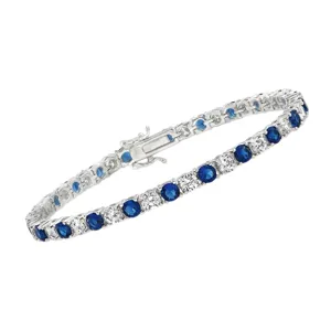 A silver tennis bracelet featuring alternating round blue and clear gemstones, secured with a clasp.