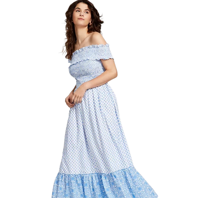 A light blue and white off-the-shoulder maxi dress featuring a smocked bodice, ruffled neckline, and tiered hem with a subtle floral pattern, offering a casual and breezy style.