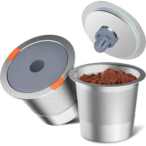 Two stainless steel reusable K-Cup pods with gray and orange lids, featuring a fine mesh design for use with ground coffee. One pod's lid is shown open, revealing the coffee grounds inside.