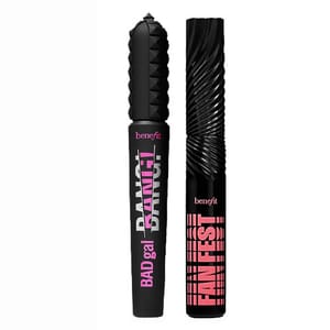 Two Benefit mascara tubes are displayed: one labeled \“BADgal BANG!\“ with a studded cap, and the other labeled \“FAN FEST\“ with a spiral-textured cap, both in black and pink designs.