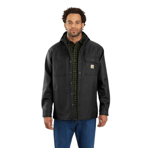 A man wears a black jacket with a hood and a Carhartt logo, over a green plaid shirt and blue jeans.