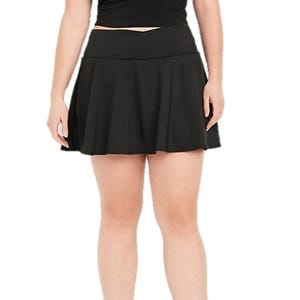 A black athletic skort featuring a flared skirt with a wide waistband. The skort combines the look of a skirt with the functionality of shorts underneath, suitable for active wear.