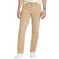 A person is wearing beige straight-leg pants paired with white sneakers and a light shirt, accessorized with a wristwatch.