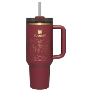 Stanley insulated travel mug with a handle, maroon color, gold design, and straw top.