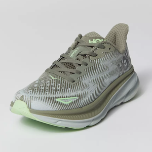 A single olive green athletic shoe with subtle pattern detailing and neon green accents.