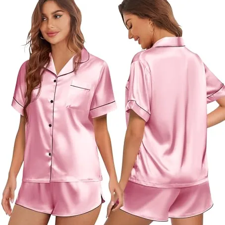 Women's satin pajama set in pink featuring a short-sleeve button-up top with a chest pocket and matching shorts, accented with black piping.
