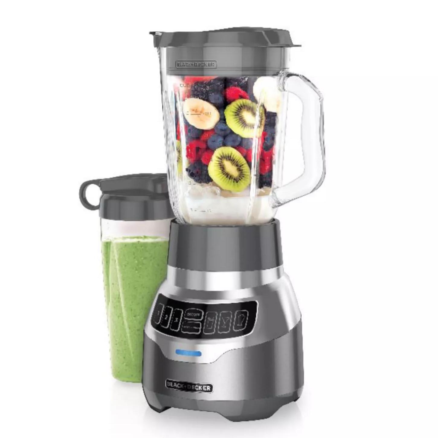 Black & Decker blender with a glass jar filled with fruits like kiwi and berries, accompanied by a blending cup containing a green smoothie.