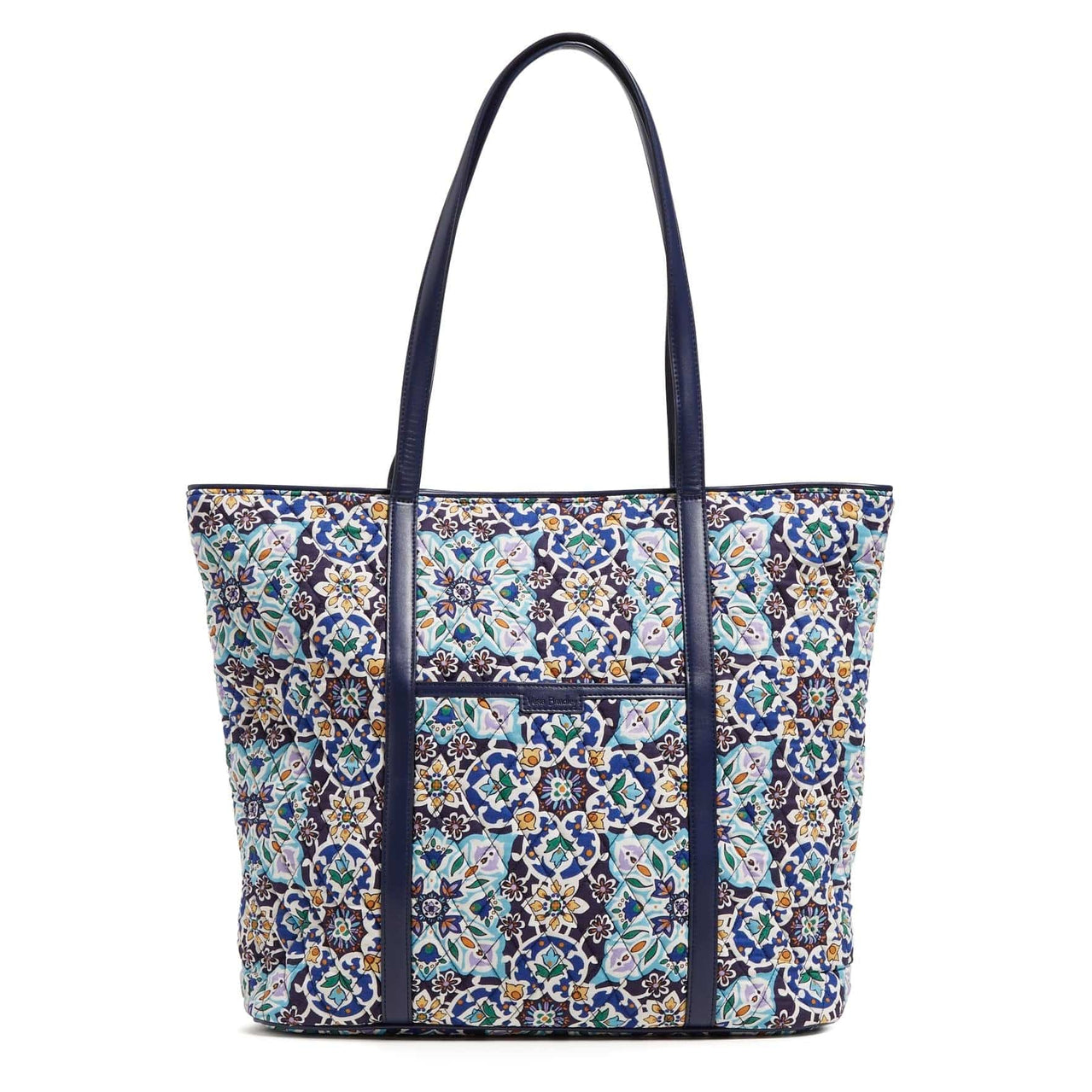 A patterned tote bag with navy blue handles and trim.