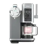 Ninja ice cream maker with a digital control panel and a milk frother attachment, designed for creating various frozen treats in a modern kitchen setup.
