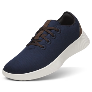 Allbirds Runner Go Shoes are casual lace-up sneakers featuring a navy blue upper, brown laces, and a contrasting white sole, designed for comfort and everyday wear.