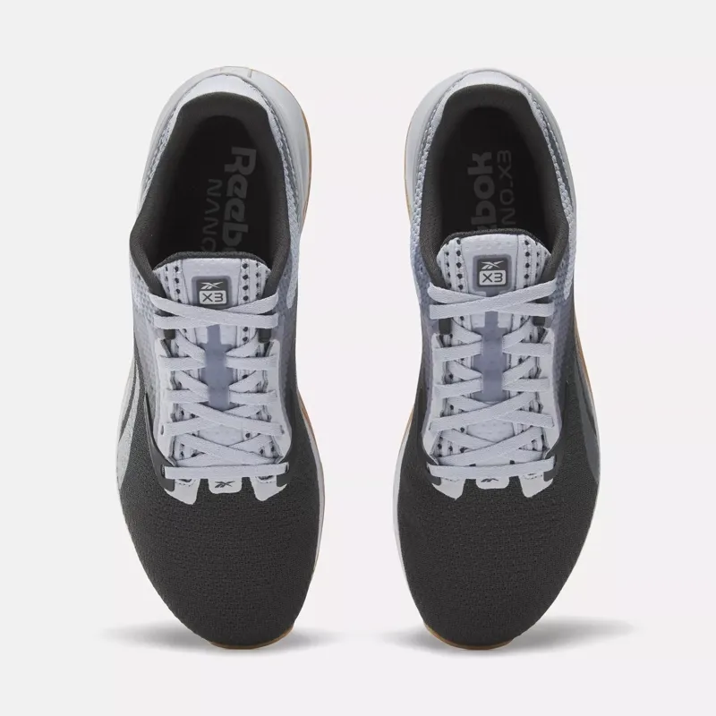 A pair of grey athletic running shoes with white laces viewed from above.